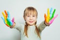 Smiling little girl with colorful painted hands. Kid art school student on white background Royalty Free Stock Photo