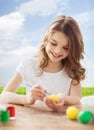 Smiling little girl coloring eggs for easter Royalty Free Stock Photo