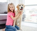 Smiling little girl cuddling cute dog Royalty Free Stock Photo