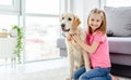 Smiling little girl cuddling cute dog Royalty Free Stock Photo