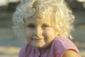 A smiling little girl with curly blond hair, Garden Grove, CA