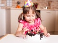 Smiling little girl discovering tasty cake