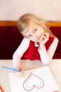 Smiling little girl draws heart. Valentine's Day Royalty Free Stock Photo