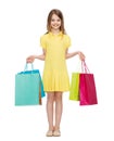 Smiling little girl in dress with shopping bags Royalty Free Stock Photo