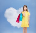 Smiling little girl in dress with shopping bags Royalty Free Stock Photo