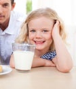 Smiling little girl drinking milk Royalty Free Stock Photo