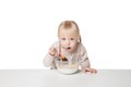 Smiling little girl eating flakes. Isolated on white background Royalty Free Stock Photo