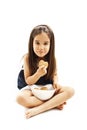 Smiling little girl eating cookie or biscuit. Royalty Free Stock Photo