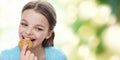 Smiling little girl eating cookie or biscuit Royalty Free Stock Photo