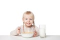 Smiling little girl eating flakes. Isolated on white background Royalty Free Stock Photo