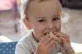Smiling little girl eating a pancake. Close-up, selective focus. A small child eats homemade pancakes. Healthy kids Royalty Free Stock Photo