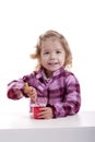 Smiling little girl eating yogurt. Royalty Free Stock Photo