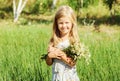 Smiling little girl with flowers Royalty Free Stock Photo