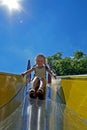 smiling little girl goes for a drive on a children& x27;s hill