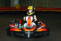 a the smiling little girl in a helmet in the go-kart on the karting track Royalty Free Stock Photo