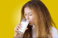 Smiling Little girl drinking a glass of milk Royalty Free Stock Photo