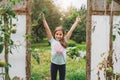 Smiling little girl holding herbs outside