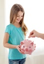 Smiling little girl holding piggy bank Royalty Free Stock Photo