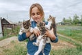 Smiling little girl holds kittens