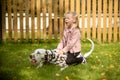 Smiling, singing little girl hugging a big dog in meadow,games outdoor.Happy child loves her pet. Positive photo of Royalty Free Stock Photo