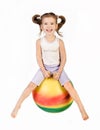Smiling little girl jumping on a big ball Royalty Free Stock Photo