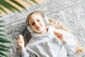 Little girl listening music lying on the floor Royalty Free Stock Photo