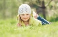 Smiling little girl lying on a lawn in the park Royalty Free Stock Photo