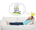 Smiling little girl lying on sofa and dreaming Royalty Free Stock Photo