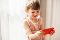 Smiling little girl with mobile phone Royalty Free Stock Photo