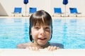 Smiling little girl in an outdoor pool Royalty Free Stock Photo