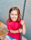 Smiling little girl on park swing Royalty Free Stock Photo