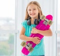 Smiling little girl with penny board Royalty Free Stock Photo