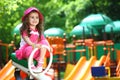 Smiling little girl in a pink hat sitting on a Royalty Free Stock Photo
