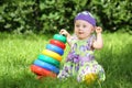 Smiling little girl playing with colorful pyramid Royalty Free Stock Photo