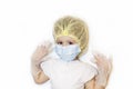 Smiling little girl is playing doctor . child in a medical uniform, hat, mask, latex gloves. baby in white uniform Royalty Free Stock Photo