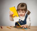Smiling little girl playing with pencils Royalty Free Stock Photo