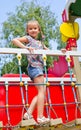 Smiling little girl playing on playground equipment Royalty Free Stock Photo