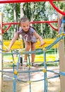Smiling little girl playing on playground equipment Royalty Free Stock Photo