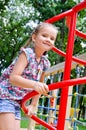 Smiling little girl playing on playground equipment Royalty Free Stock Photo