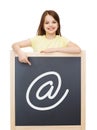 Smiling little girl pointing finger to blackboard Royalty Free Stock Photo