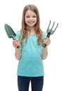 Smiling little girl with rake and scoop