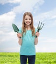 Smiling little girl with rake and scoop Royalty Free Stock Photo