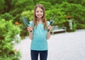 Smiling little girl with rake and scoop Royalty Free Stock Photo