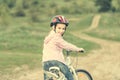 Smiling little girl riding a bike turned away Royalty Free Stock Photo