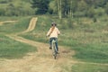 Smiling little girl riding a bike turned away Royalty Free Stock Photo