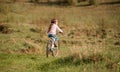 Smiling little girl riding a bike turned away Royalty Free Stock Photo