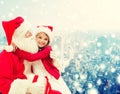 Smiling little girl with santa claus and gifts Royalty Free Stock Photo