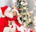 Smiling little girl with santa claus Royalty Free Stock Photo