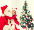 Smiling little girl with santa claus Royalty Free Stock Photo