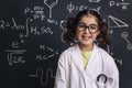 Smiling little girl science student in lab coat